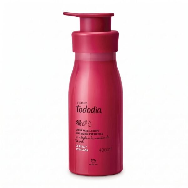 Fotografía de producto sobre fondo blanco uniforme. En el centro aparece un envase cilíndrico de plástico en color fucsia o cereza Intenso con dispensador de presión (válvula pump). La botella contiene crema corporal de la marca Natura, línea Tododia. En la parte frontal se lee la marca "natura tododia" en letras negras estilizadas, acompañada de tres pequeñas ilustraciones botánicas de cerezas y avellanas. Más abajo, el texto impreso indica: "CREMA PARA EL CUERPO NUTRICIÓN PREBIÓTICA se adapta a los cambios de tu piel", seguido por la fragancia "CEREZA Y AVELLANA", el contenido neto "400ml" y el logotipo de Natura cerca de la base.